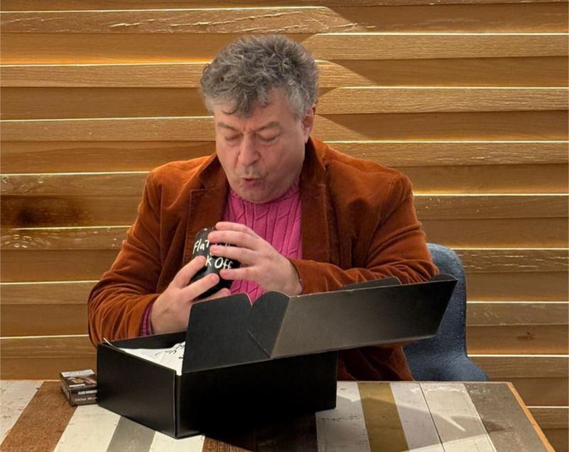 Rory opening a gift box from Flat white or f*ck off